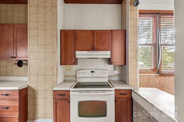 kitchen with backsplash and white electric stove