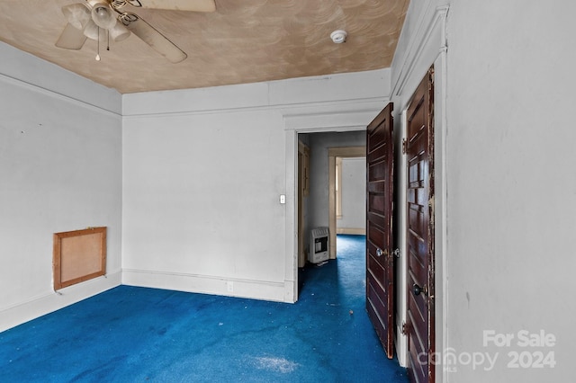 empty room with heating unit and ceiling fan