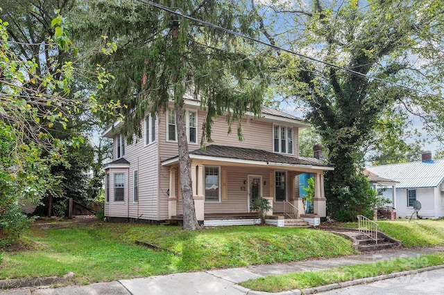 view of front facade featuring covered porch and a front yard