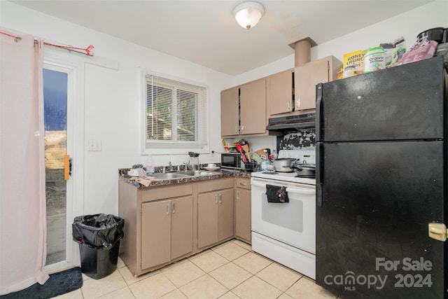 kitchen featuring light tile patterned floors, white range with electric cooktop, sink, and black refrigerator