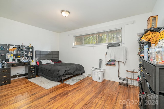 bedroom with hardwood / wood-style flooring