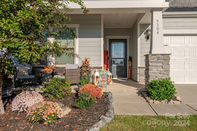 view of exterior entry featuring covered porch