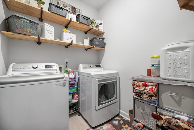 clothes washing area with washing machine and dryer