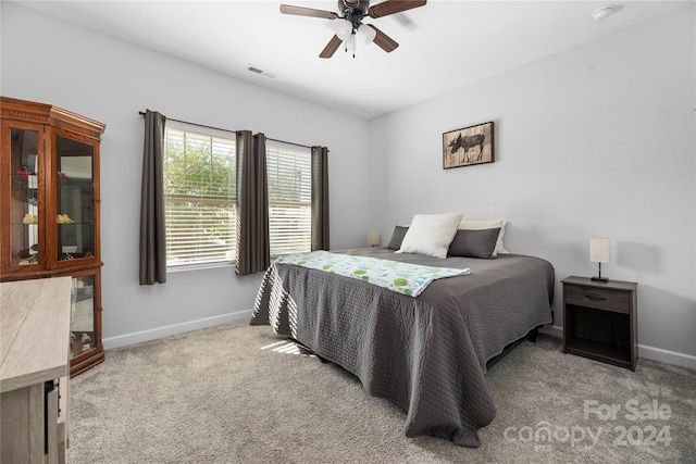 bedroom with light colored carpet and ceiling fan