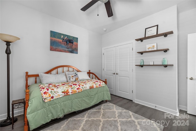 bedroom with a closet, dark hardwood / wood-style floors, and ceiling fan