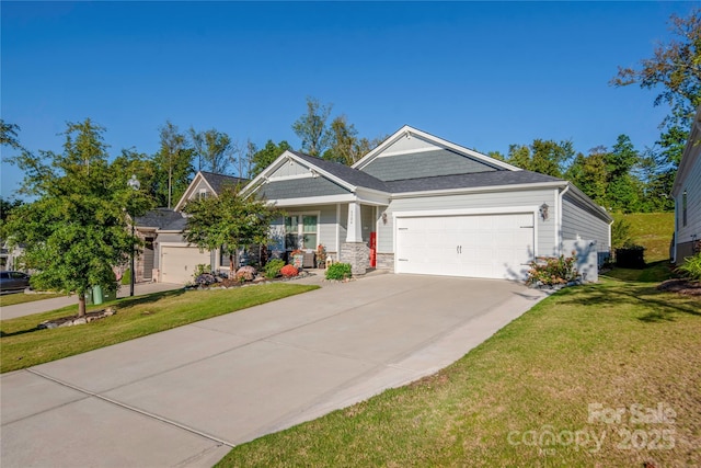 craftsman-style house with concrete driveway, stone siding, a front yard, and a garage