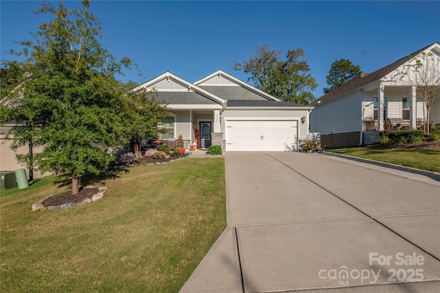 craftsman-style house featuring an attached garage, a front yard, and concrete driveway