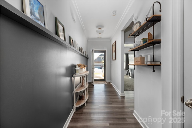 hallway with baseboards, ornamental molding, and dark wood finished floors