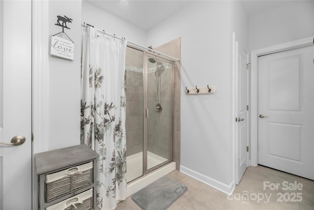 full bathroom with baseboards, tile patterned floors, and a stall shower