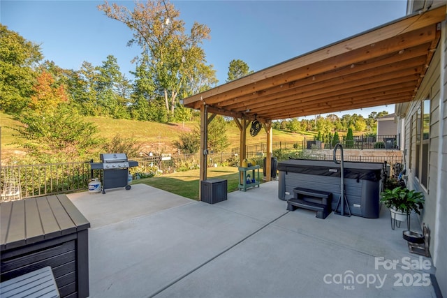 view of patio / terrace with a fenced backyard, a hot tub, and area for grilling