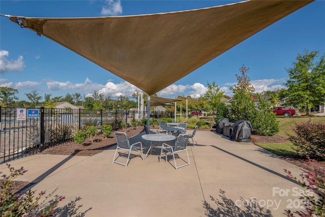 view of patio with fence and outdoor dining space
