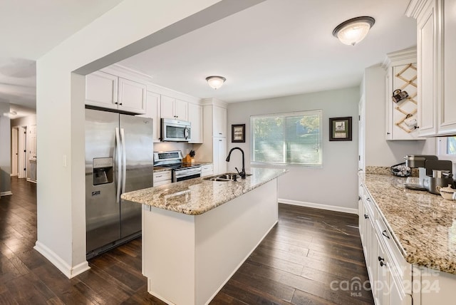 kitchen with appliances with stainless steel finishes, white cabinetry, a center island, dark hardwood / wood-style floors, and sink