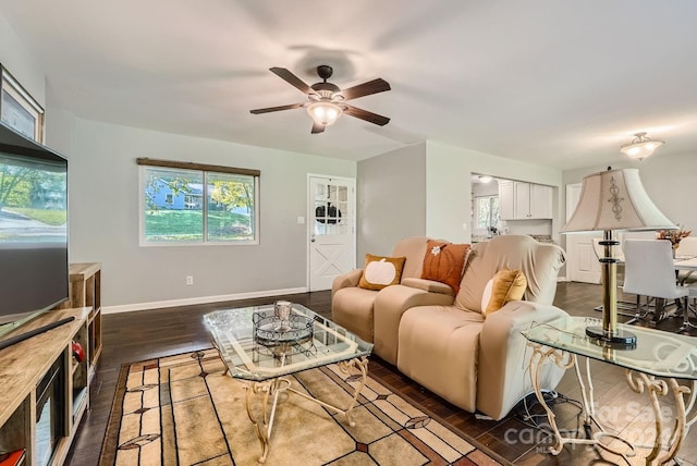 living room featuring dark hardwood / wood-style flooring and ceiling fan