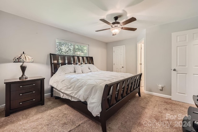 bedroom featuring light carpet and ceiling fan