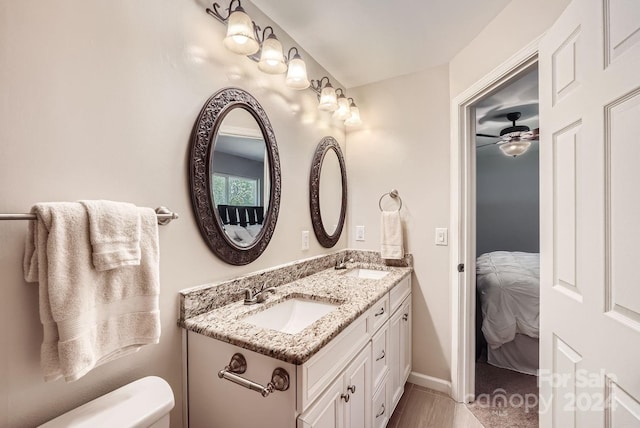 bathroom featuring ceiling fan, vanity, and toilet