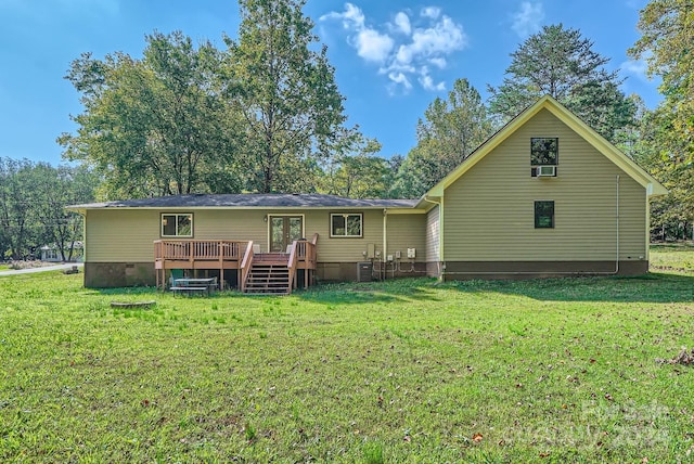 rear view of property featuring a deck and a yard