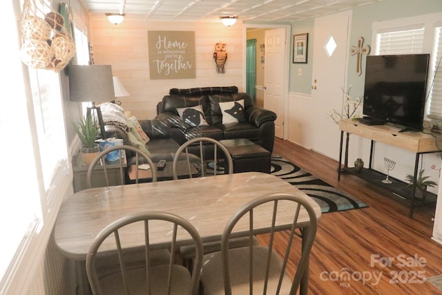 living room with wood walls and hardwood / wood-style flooring