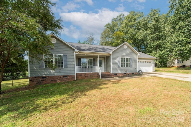 ranch-style house with a front lawn, a garage, and covered porch