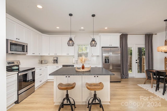 kitchen featuring plenty of natural light, light hardwood / wood-style floors, and stainless steel appliances