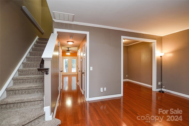 staircase featuring ornamental molding, ceiling fan, hardwood / wood-style floors, and french doors