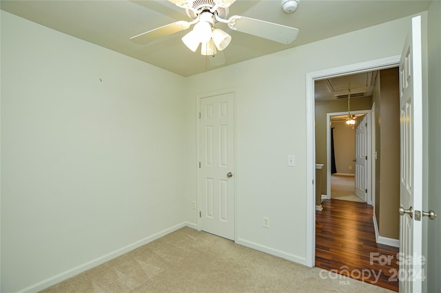 unfurnished bedroom featuring ceiling fan, light hardwood / wood-style flooring, and a closet