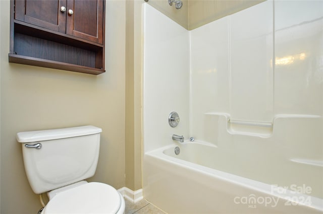 bathroom featuring  shower combination, toilet, and tile patterned floors