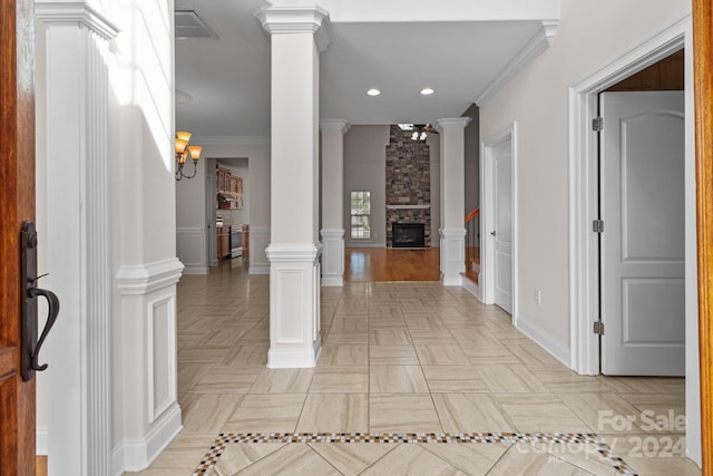 hall with ornate columns, crown molding, and recessed lighting