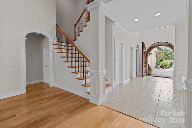 entryway featuring light hardwood / wood-style flooring and ornamental molding