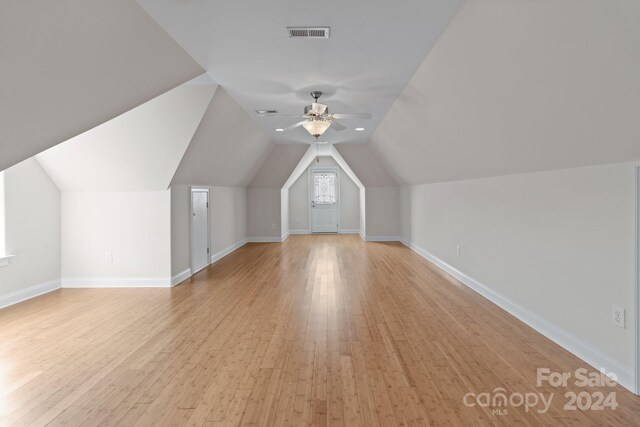 additional living space with ceiling fan, vaulted ceiling, and light hardwood / wood-style floors