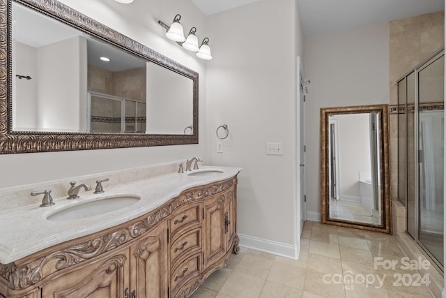 bathroom featuring tile patterned floors, a shower with door, and vanity