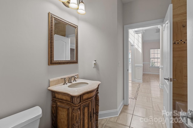 bathroom featuring tile patterned flooring, vanity, and toilet