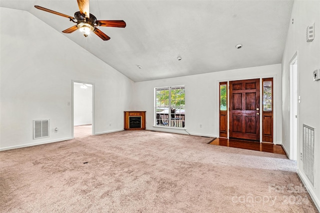 unfurnished living room featuring high vaulted ceiling, carpet floors, and ceiling fan