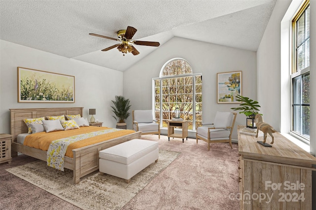 bedroom with a textured ceiling, carpet, lofted ceiling, and ceiling fan