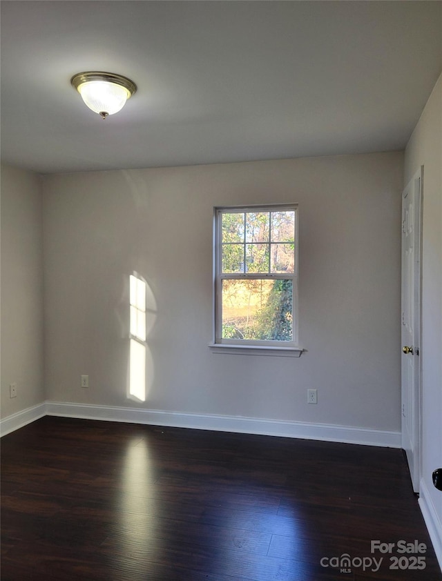 empty room featuring dark hardwood / wood-style floors