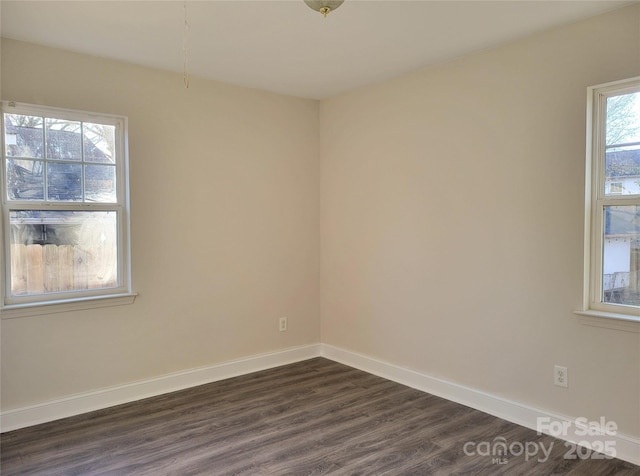 spare room with dark hardwood / wood-style floors