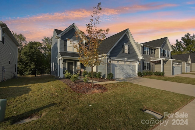 view of front of property with a lawn and a garage