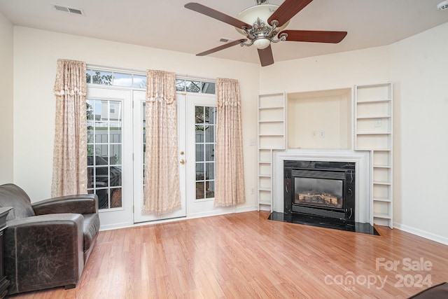 unfurnished living room featuring wood-type flooring and ceiling fan