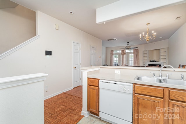 kitchen with hanging light fixtures, ceiling fan with notable chandelier, white dishwasher, light parquet floors, and sink