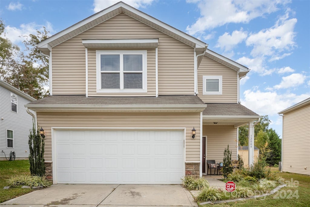 12009 Downy Birch Rd, Charlotte, NC 28227 - traditional-style home featuring driveway, stone siding, and a garage