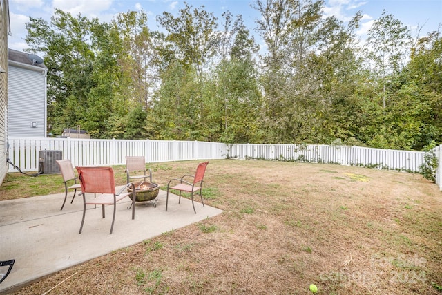 view of yard with a fire pit, a patio area, and central AC unit