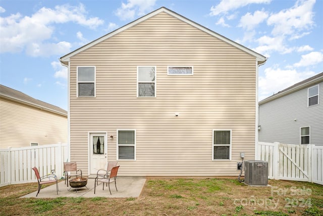 rear view of house featuring a patio, a fire pit, and central AC unit