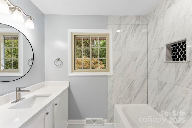 bathroom featuring vanity and tiled shower / bath combo