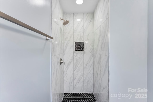 bathroom with a tile shower