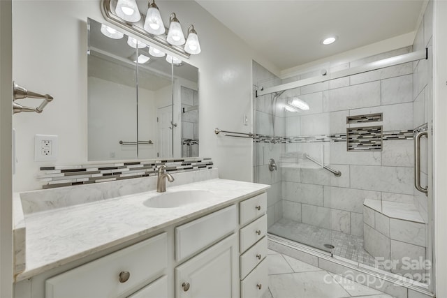 bathroom with decorative backsplash, a shower with door, and vanity