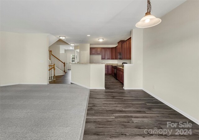 kitchen with hanging light fixtures, dark wood-type flooring, and a kitchen island