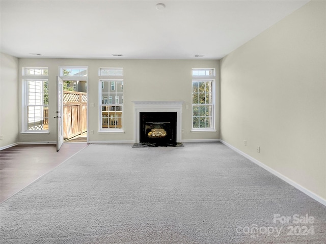 unfurnished living room with light carpet