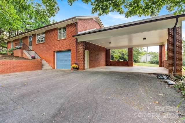 view of home's exterior with a carport and a garage