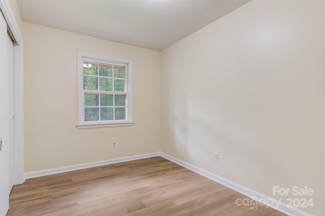 unfurnished room with light hardwood / wood-style flooring