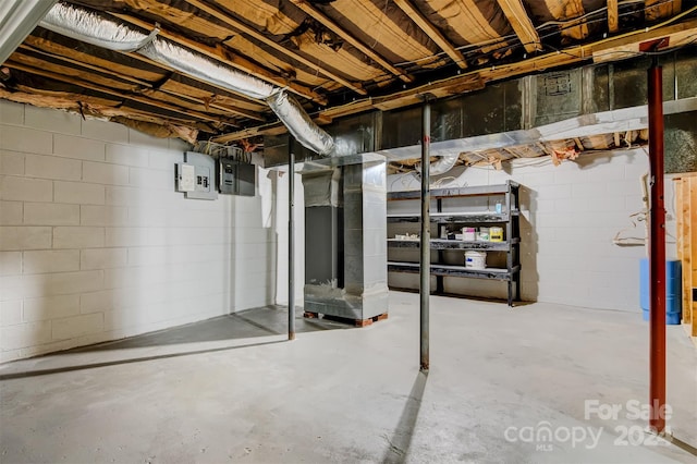 basement with electric panel and heating unit