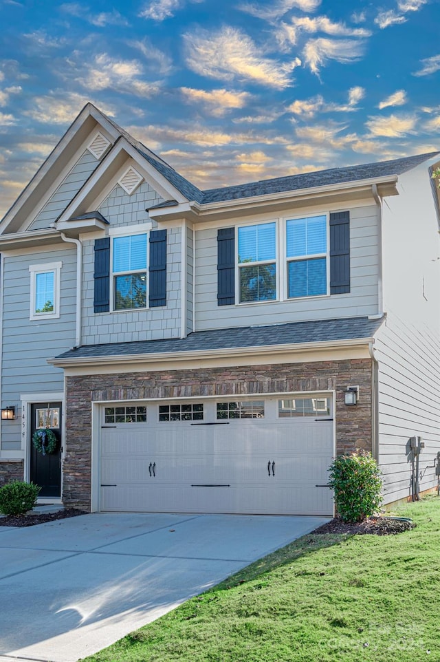 view of front of house featuring a garage and a front yard